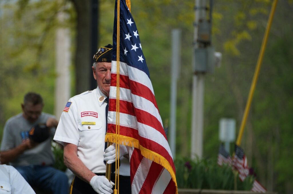 A veteran holding a flag during Memorial Day ceremonies
