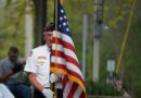 A veteran holding a flag during Memorial Day ceremonies