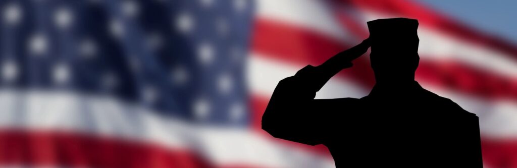 A soldier saluting the American flag